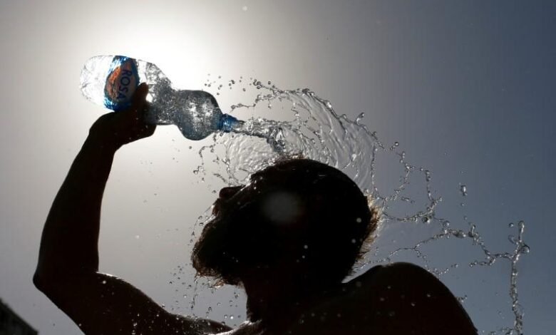A Man Pours Water On His Face To Cool Off From Hot Weather In Skopje